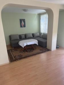 a living room with a couch and a coffee table at Къща Бети самостоятелни апартаменти с двор край Пловдив in Skutare +26 photos