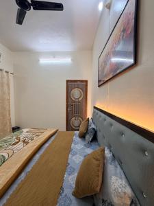 a bedroom with a large bed with a large headboard at Devansh Palace Near Ram Mandir in Ayodhya