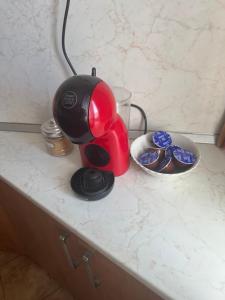 a red coffee maker sitting on top of a counter at Къща Бети самостоятелни апартаменти с двор край Пловдив in Skutare