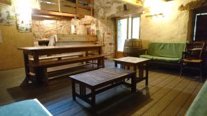 a room with benches and a table and a couch at Maison de Vignes de Tournemire in Tournemire