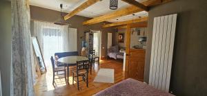 a living room with a table and a dining room at Kempings Liepene in Liepene