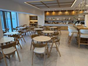 a restaurant with tables and chairs and a counter at Ammos Paleochora Hotel in Palaiochora