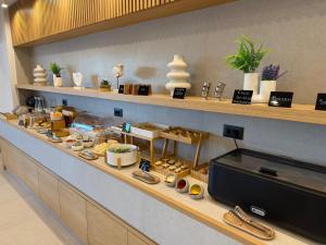 a counter in a restaurant with food on it at Ammos Paleochora Hotel in Palaiochora +24 photos