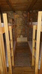 an attic room with two bunk beds and a desk at Maison de Vignes de Tournemire in Tournemire
