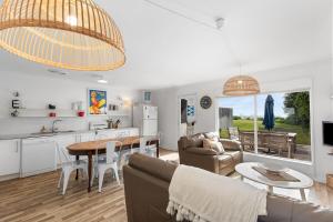 a kitchen and living room with a couch and a table at No 5 Red Right on the beach! in Robe