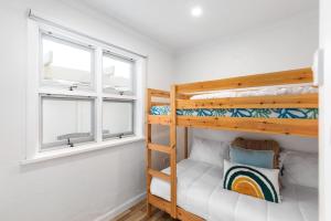 a bedroom with two bunk beds and a window at No 5 Red Right on the beach! in Robe