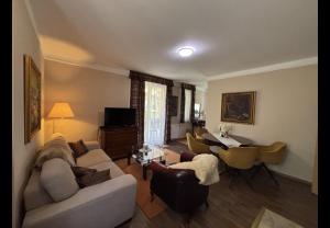 a living room with a couch and a table at Apartman Golf Lux in Bük