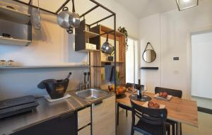 a kitchen with a sink and a table with chairs at Le Vele - Contro Fiocco in Rosolina