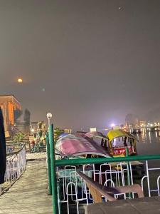 a boat is docked on a pier at night at Budget Cottage By Aristotle in Srinagar