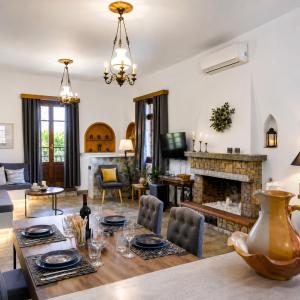a living room with a table and a fireplace at Efcharis house Skopelos in Neo Klima