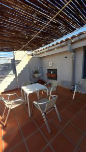 a patio with a table and chairs on a roof at Loft El Carmen in Teruel +16 photos