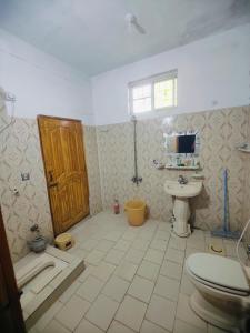 a bathroom with a toilet and a sink at AR Apartment in Khaira Gali