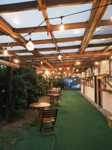 an outdoor patio with tables and chairs and lights at 耶舍 yes sir 潛水旅宿1館2館 in Green Island