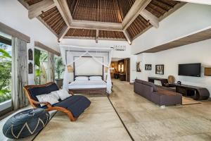 a living room with a bed and a couch at Ayurvedagram Bali - Wellness & Retreat Resort in Ubud