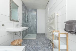 a bathroom with a sink and a shower at Boutique 54° Nord in Büsum +54 photos