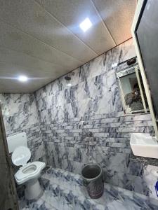 a bathroom with a toilet and a sink at Serenity House in Matheran +4 photos