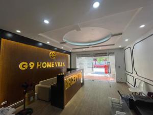 a lobby with a go home villa sign on the wall at G9 home hotel in Hanoi