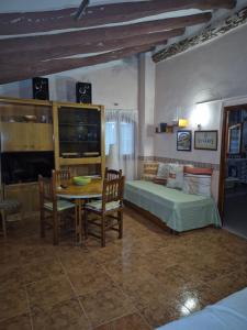 a bedroom with a bed and a table and chairs at Casa Irlia in García