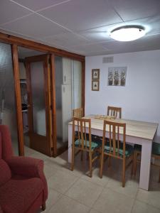 a kitchen with a dining room table and chairs at Casa Irlia in García +12 photos