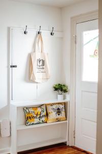 a room with pillows and a bag on a wall at Green on New in Staunton