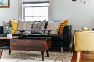 a living room with a blue couch with pillows at Green on New in Staunton +33 photos