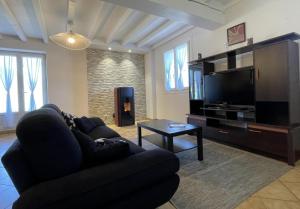 a living room with a couch and a flat screen tv at Chez bourdet-pelou in Arette