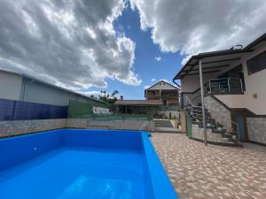 a blue swimming pool in front of a house at Pescariei Nr5 in Sarichioi