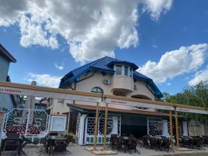 a building with tables and chairs in front of it at Pescariei Nr5 in Sarichioi