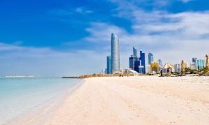 a view of a beach with a city in the background at Banny Homes - Cozy Suite Apartment - Downtown in Abu Dhabi