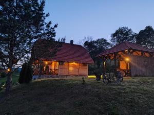 a small wooden cabin with a gazebo at night at Villa RESET in Zlatibor