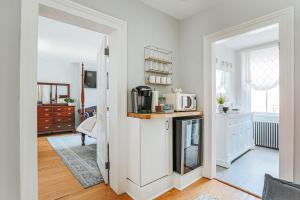 a room with a kitchen with a microwave at Magnolia Suite in Staunton