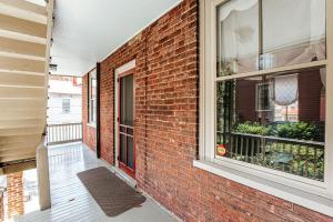 a brick building with a window and a balcony at Magnolia Suite in Staunton
