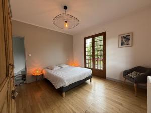 a bedroom with a bed and a chair and a window at Arlotia in Ascarat +41 photos