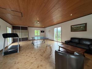 a living room with a couch and a table at Arlotia in Ascarat