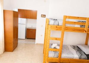 a room with two bunk beds and a kitchen at Beautiful Sea View Borsh in Borsh