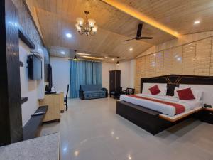 a bedroom with a bed and a television in it at Hotel Biaspushp Dalhousie in Banikhet