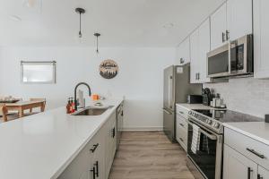 a white kitchen with white cabinets and a sink at Mountain View Vista in Mount Torry Furnace