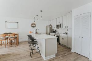 a kitchen with white cabinets and a kitchen island with bar stools at Mountain View Vista in Mount Torry Furnace