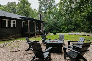a patio with chairs and a table and a cabin at Nelson Cozy Cabin in Nellysford +36 photos