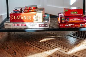 a stack of books sitting on a shelf at Nelson Cozy Cabin in Nellysford