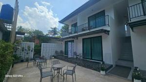 a patio with chairs and tables in front of a building at Beas Place Klong Dao in Ko Lanta
