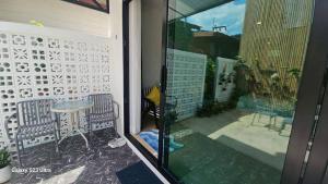 a glass door with a table and chairs on a balcony at Beas Place Klong Dao in Ko Lanta