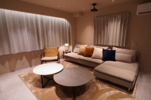 a living room with a couch and a table at TABISAI HOTEL Premium 博多-中洲 in Fukuoka