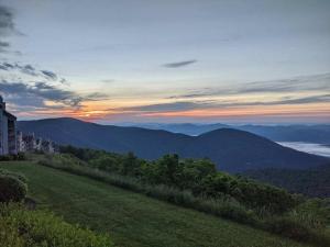 a view of the mountains with a building on a hill at Panoramic Peak in Mount Torry Furnace