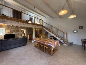 a living room with a staircase and a table and chairs at Juanttipienea in Souraïde