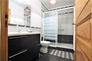 a bathroom with a toilet and a glass shower at Juanttipienea in Souraïde +22 photos