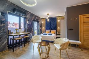 a bedroom with a bed and a table and chairs at Golden Eagle Luxury Apartment - Granary Island- Gdańsk Old Town in Gdańsk
