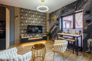a living room with a table and chairs at Golden Eagle Luxury Apartment - Granary Island- Gdańsk Old Town in Gdańsk