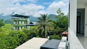 a view of a building from the balcony of a house at Bao An Homestay Mai Chau in Mai Châu