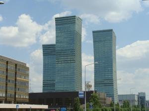 dois arranha-céus de vidro numa cidade em Vip House Hotel em Astana